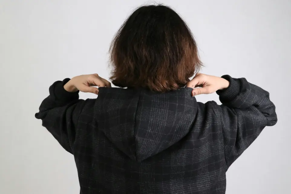 a woman wearing a black and white checkered jacket